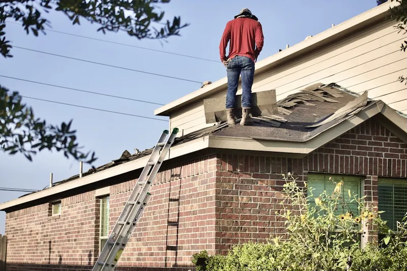 Professional roofer working on a residential roof in Firestone Park